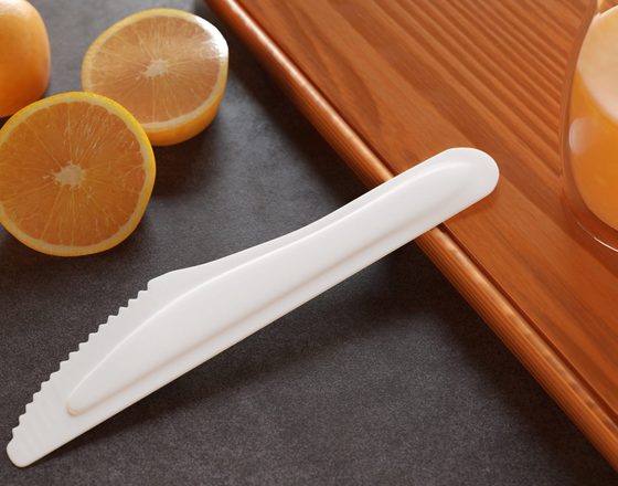 Paper knife next to fresh oranges